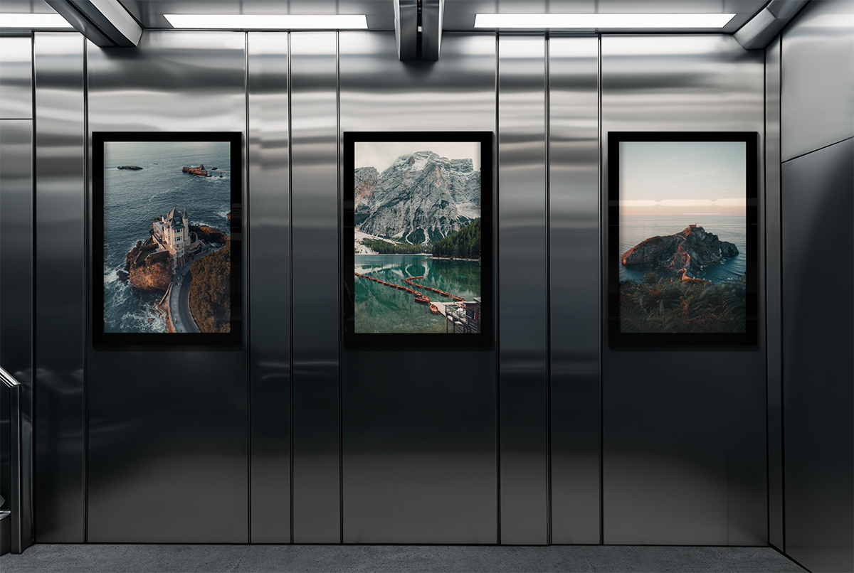 Image of a wall with framed landscape pictures.